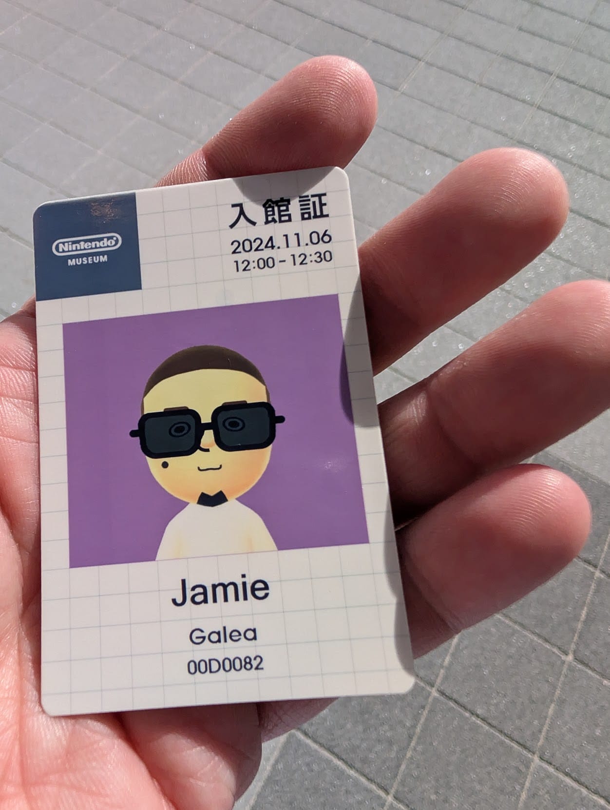 An identification card for the Nintendo museum featuring a Mii version of the author.