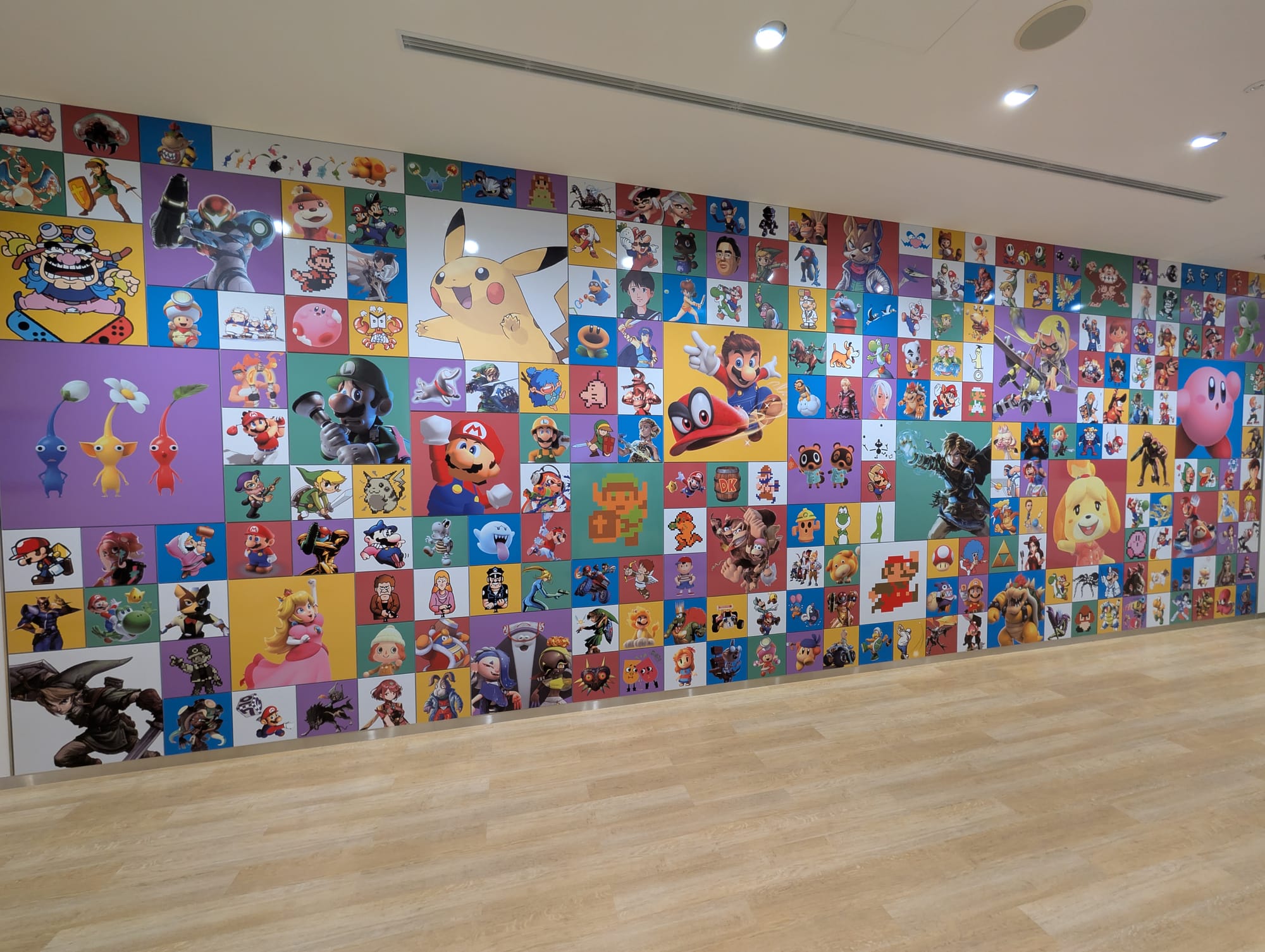 A collage wall of Nintendo franchise characters on solid-color backgrounds.