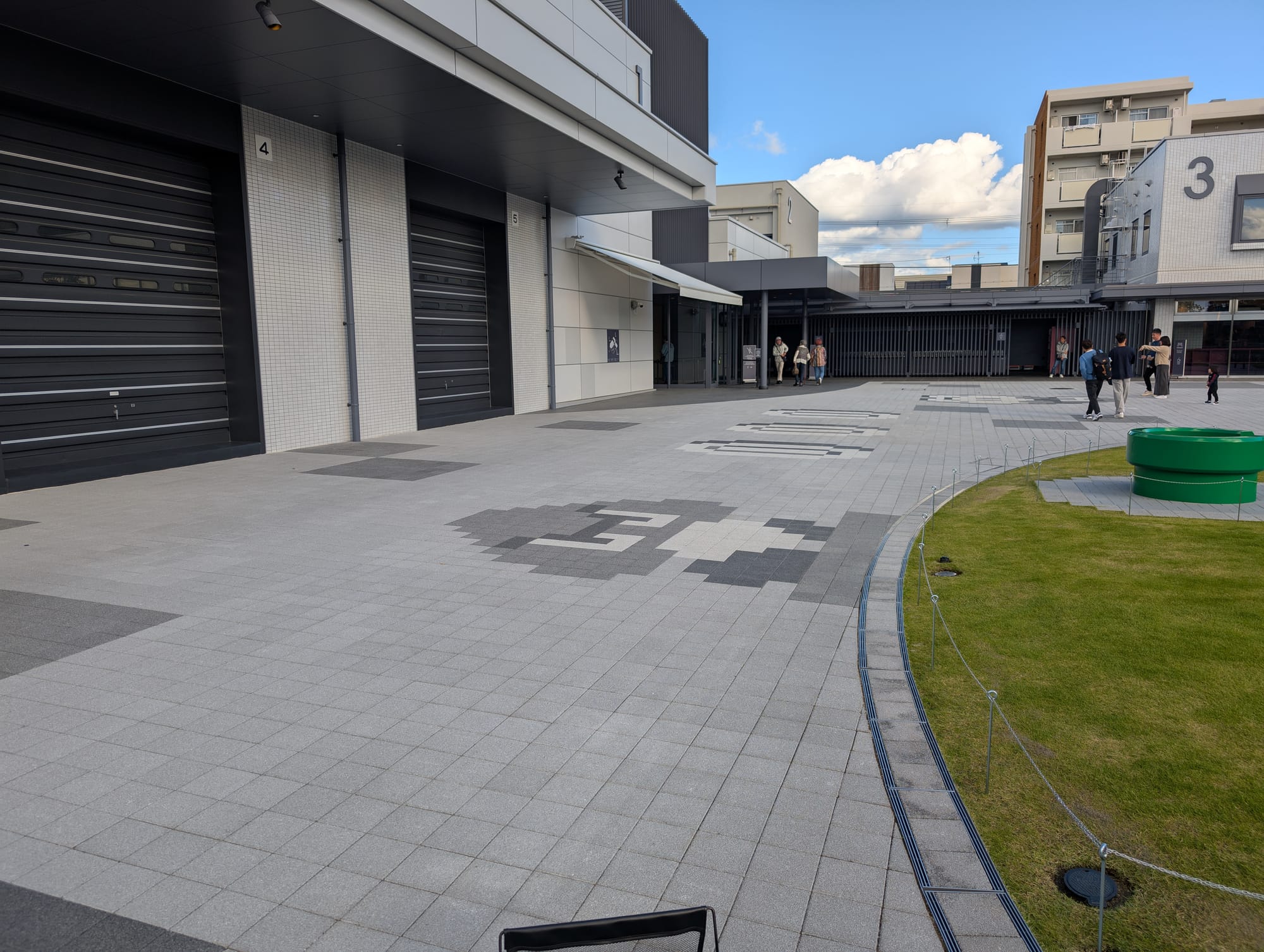 The exterior courtyard, with Goombas and coins from the Mario games built in to the paving.