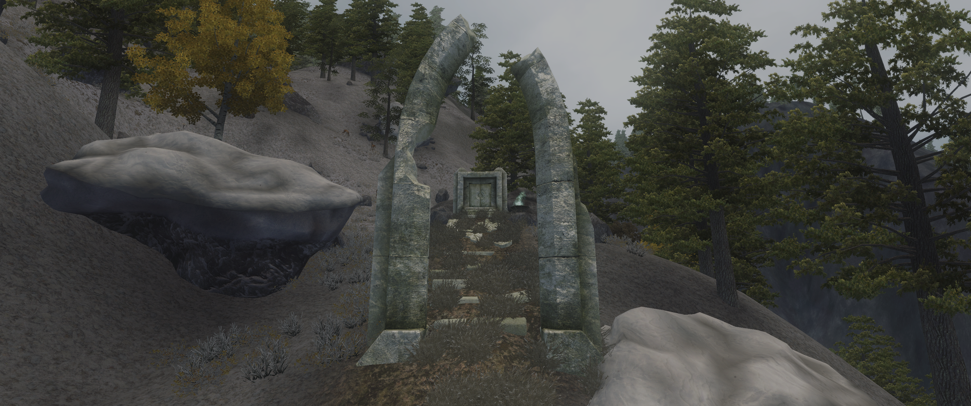 Screenshot from the game. The ruins of a stone building on a wooded mountainside.